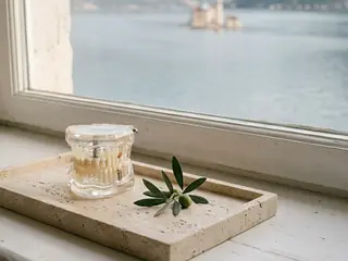 A jaw model on a stone tray by the window, with the bay and the island church behind it.